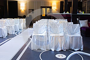 Wedding venue with decorative white chairs