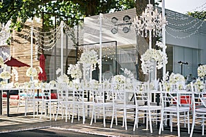 The wedding venue for reception dinner table decorated with white orchids, white roses, flowers, floral, white chiavari chairs lin