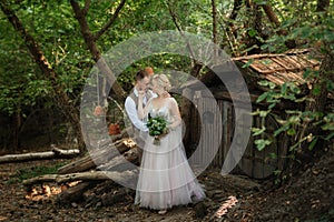 wedding walk of the bride and groom in a coniferous in elven accessories