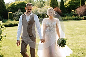 wedding walk of the bride and groom in a coniferous in elven accessories