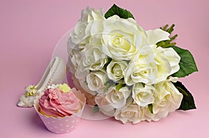 Wedding white roses bouquet with pink cupcake