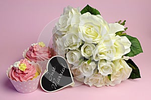 Wedding white roses bouquet with pink cupcake and Just Married sign.