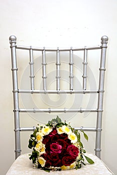 Weddings, bouquets and chairs and plain backdrops