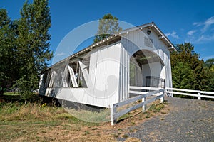 The Weddle Bridge, a white covered bridge near Sweet Home, Oregon, spans Ames Creek