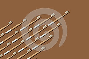 Wedge or arrow shaped bamboo toothbrushes on brown background