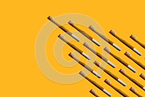 Wedge or arrow shaped bamboo toothbrushes on yellow background