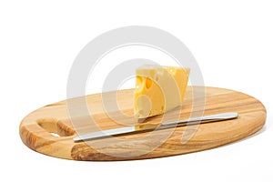 Wedge of cheese and knife on a cheese board