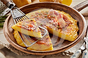 Wedge of fluffy potato egg pancake on spatula