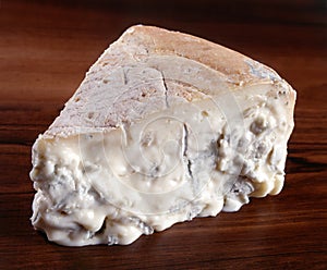 A wedge of gorgonzola cheese