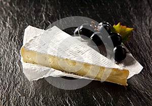 Wedge of ripe brie cheese photo