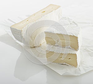 Wedges of french brie cheese on white background