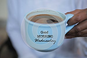 Cup of coffee. Good morning Wednesday greeting on cup of coffee. Morning coffee concept. photo
