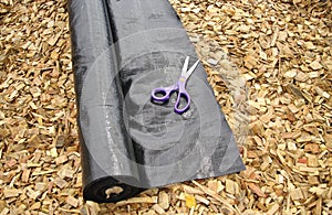 Weed matting mulch and scissors