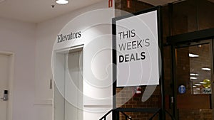 This week`s deals billboard beside elevators