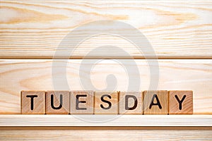 Weekday on wooden blocks. Vintage letterpress printing blocks. Tuesday on toy cubes. Tuesday background. Name of weekday