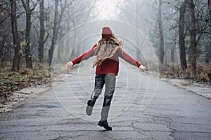 Weekend breaks and getaways in forests. Stay close to nature. Young woman in red hat and sweater