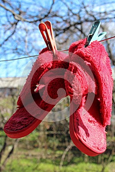 Weekend on dacha, red slippers hanging to dry off