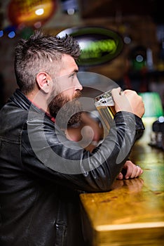 Weekend lifestyle. Pub great place to dine drink and have fun. Hipster relaxing at pub. Guy bearded man sit at bar