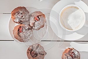 weekend morning sweet treat, coffee and berry muffins, home baked cakes with sugar powder