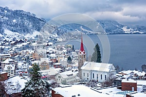 Weggis village on Lake Lucerne, swiss Alps mountains, Switzerland, in winter time