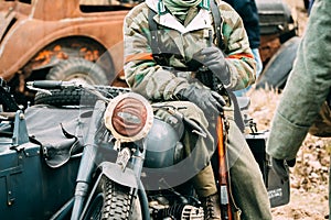 Wehrmacht soldiers on a motorcycle with a rifle