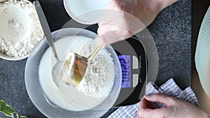 Weighing flour for baking bread, making or feeding sourdough starter at home, top view