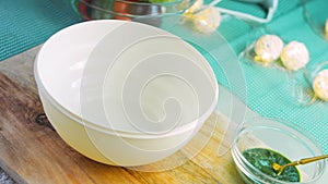 Weighing flour on a scale. Female hands pour flour from a paper bag into a transparent bowl of kitchen scales. Preparing