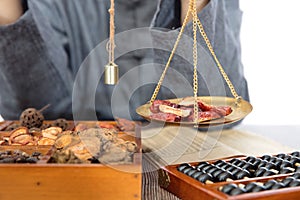 Weighing traditional Chinese medicine by TCM pharmacists photo