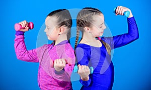 Weight lifting for bodycare muscules. Childhood bodycare. Fitness diet for energy health. Happy children with barbell