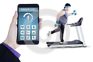 Weight loss app and man exercising on treadmill