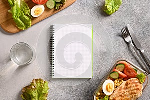 Weight loss concept, calories counting, diet, food control and calorie counter, diet plan. Notebook, food, salad, egg