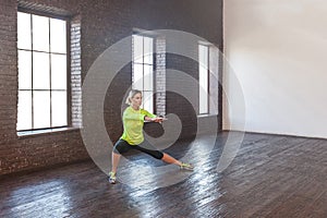 Weight loss concept. Seriously woman doing gymnastics indoor