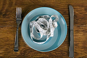 Weight loss concept with tape measure on plate