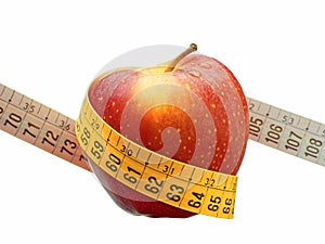 Weight loss and healthy dieting concept red apple measuring tape isolated