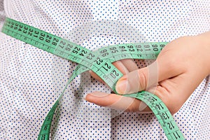 Weight Loss and Healthy Lifestyle Concept. Fitness Woman Measuring Her Waistline with Measure Tape