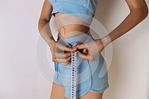 Weight loss, healthy lifestyle concept, measuring tape on woman body
