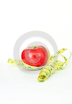 Weight Loss .Measuring tape wrapped around a apple