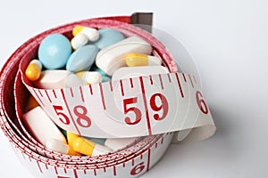 Weight loss pills and measuring tape