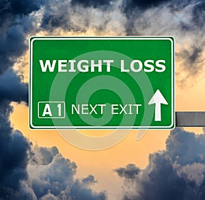 WEIGHT LOSS road sign against clear blue sky