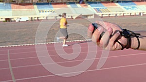 weight loss, running training in the stadium under the guidance of a coach with a stopwatch