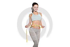 Weight loss, sports girl measuring her waist