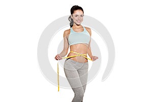 Weight loss, sports girl measuring her waist photo