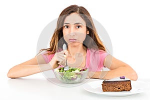 Weight loss woman eating salad wishing for a piece of cake