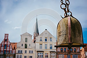 Weight of old Crane hanging in front of facade of historical buildings in Harbor Lueneburg, Lower Saxony,Germany