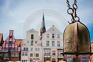 Weight of old Crane hanging in front of facade of historical buildings in Harbor Lueneburg, Lower Saxony,Germany