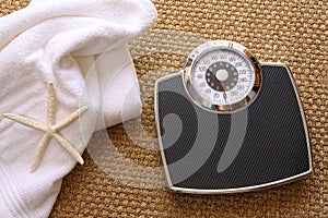 Weight scale with towel on carpet