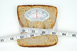 Weight scale with wholesome slice of bread and measuring tape on