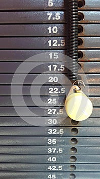 Weight stack gray scale with graduation in kilograms with yellow pin photo