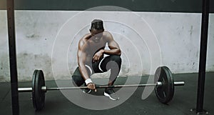 Weightlifting, bodybuilder and black man with barbell in gym for training, exercise and strong workout. Fitness, muscles