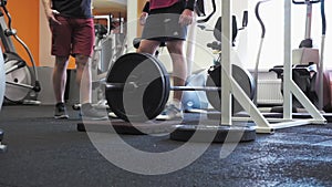 Weightlifting fitness man having a chat with trainer in the gym before deadlift set